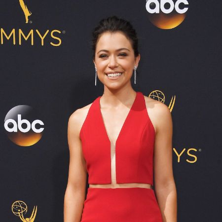 Tatiana Maslany wears a red dress for an event